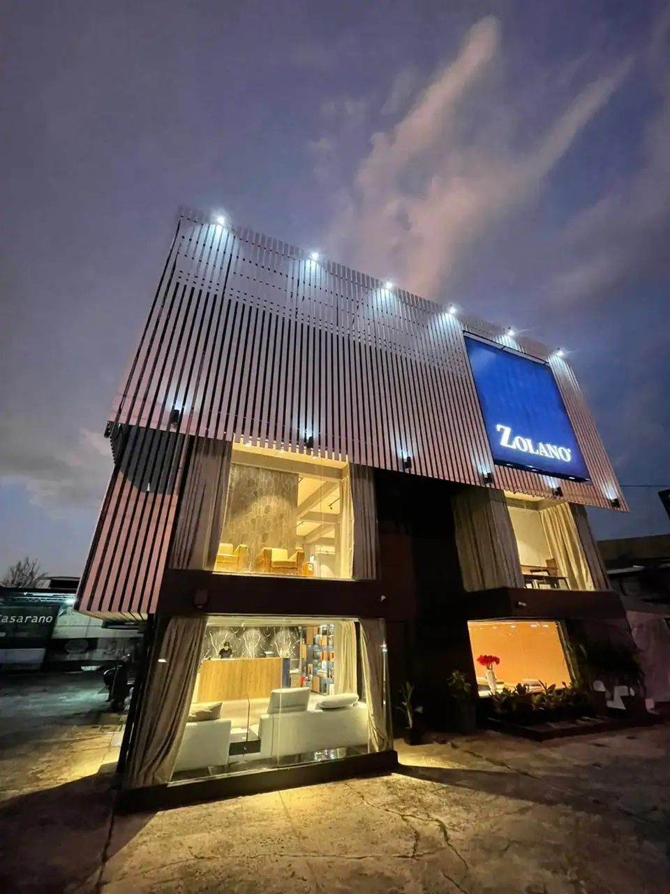 A stunning modern showroom building in Kota Kinabalu, Sabah, illuminated at night.