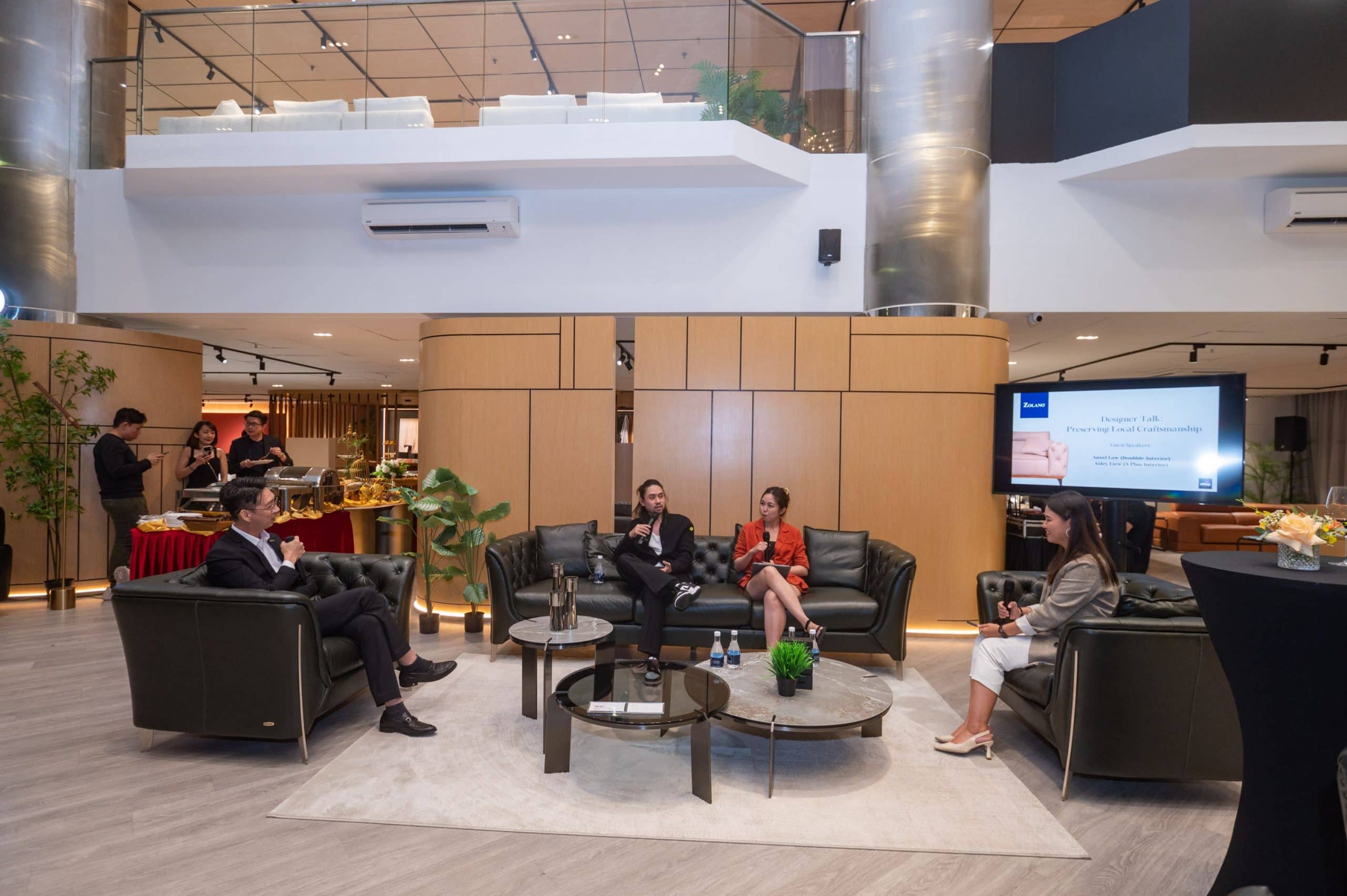 Modern hotel lobby with stylish black leather sofas and contemporary decor.
