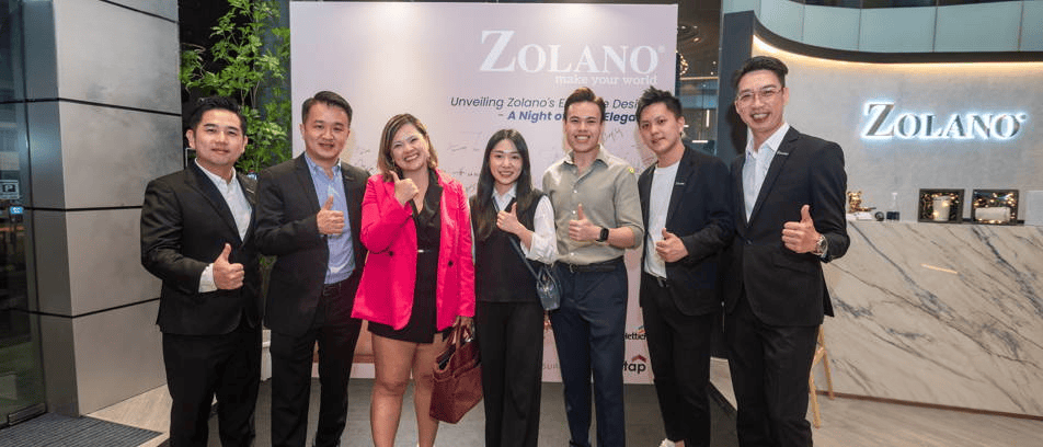 Elegant group of people at Zolano furniture unveiling event, modern design, professional setting.