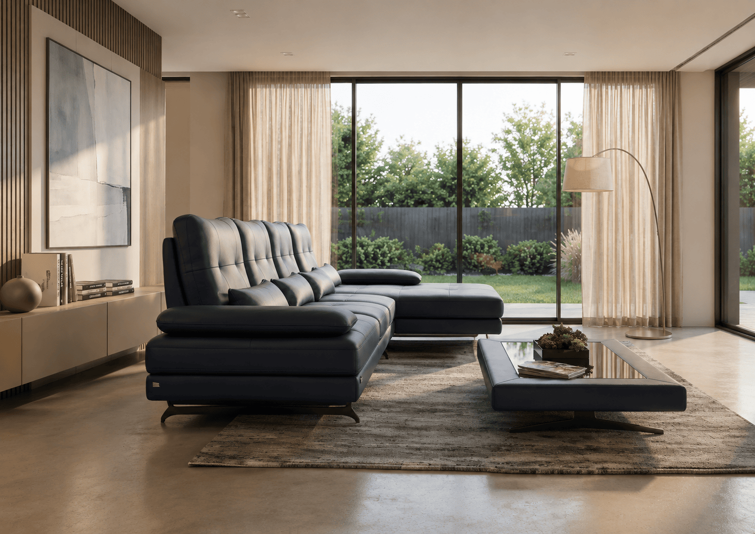 Modern living room with black leather sofa and large glass windows overlooking garden.