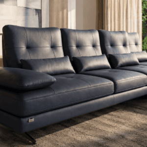 Modern black leather sofa with cushions in a stylish living room setting.