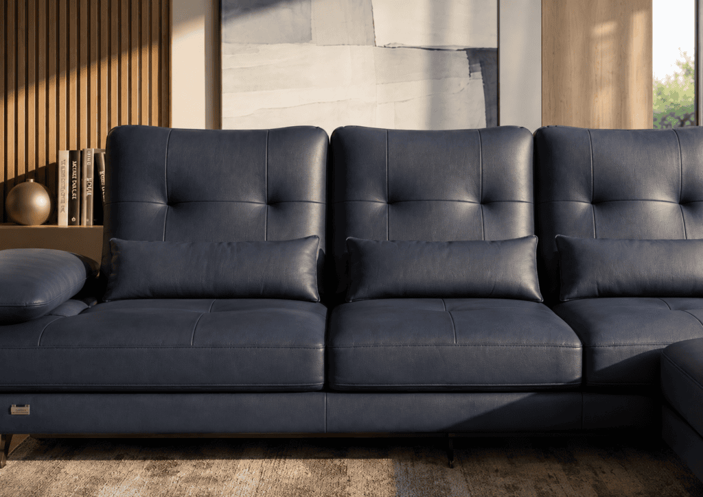 Modern navy blue leather sofa in stylish living room with wooden accents.