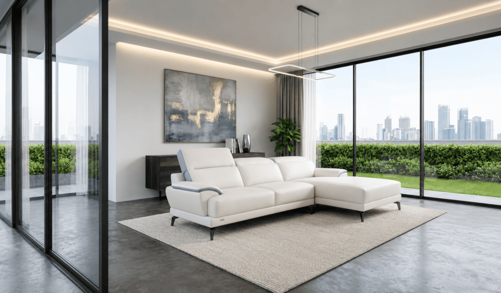 Modern living room with white sofa and city view through large windows.