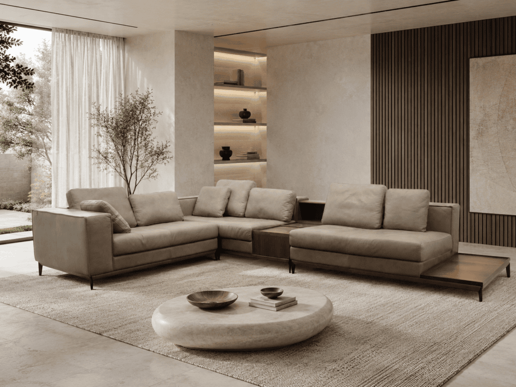 Modern living room with beige sofas, round coffee table, and natural light.