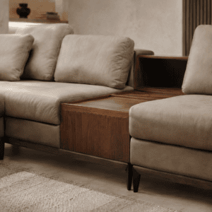 Modern beige sofa with wooden side table in contemporary living room.