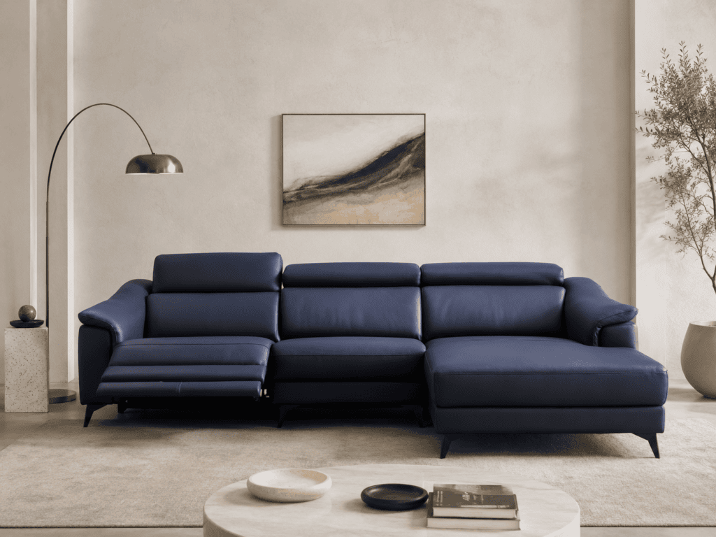 Modern navy blue sectional sofa in a minimalist living room with artwork and plants.