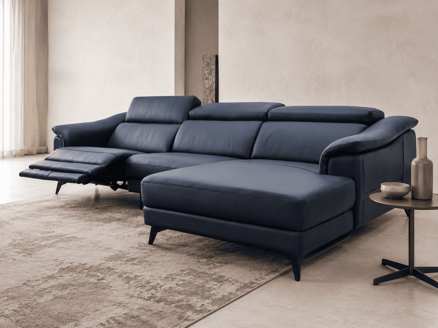 Modern navy blue sectional sofa in a stylish living room setting.