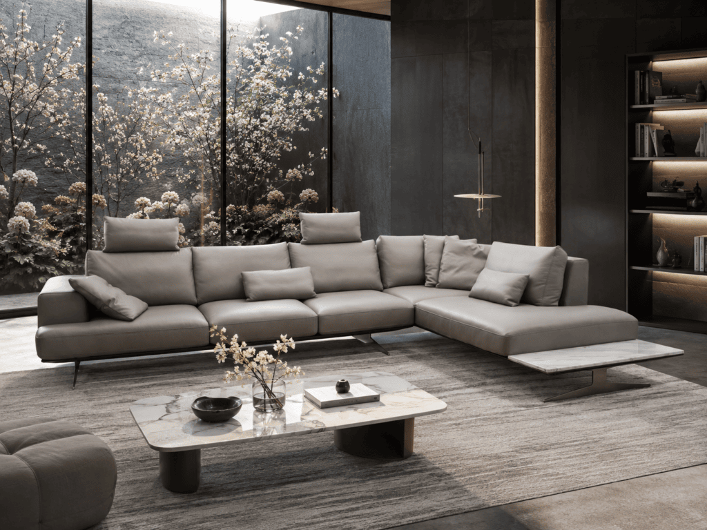Modern grey sectional sofa in a stylish living room with large window and garden view.