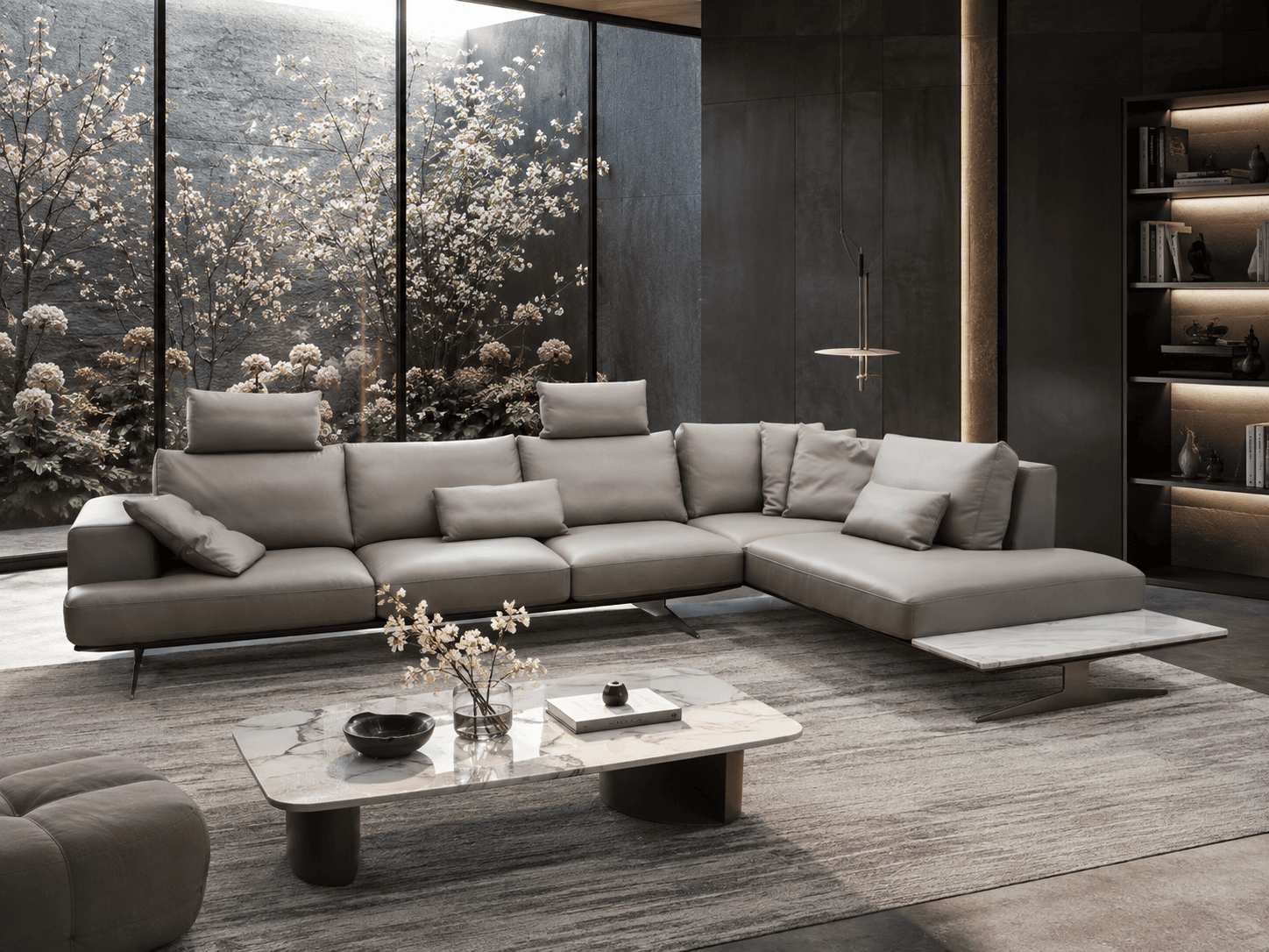 Modern grey sectional sofa in a stylish living room with large window and garden view.