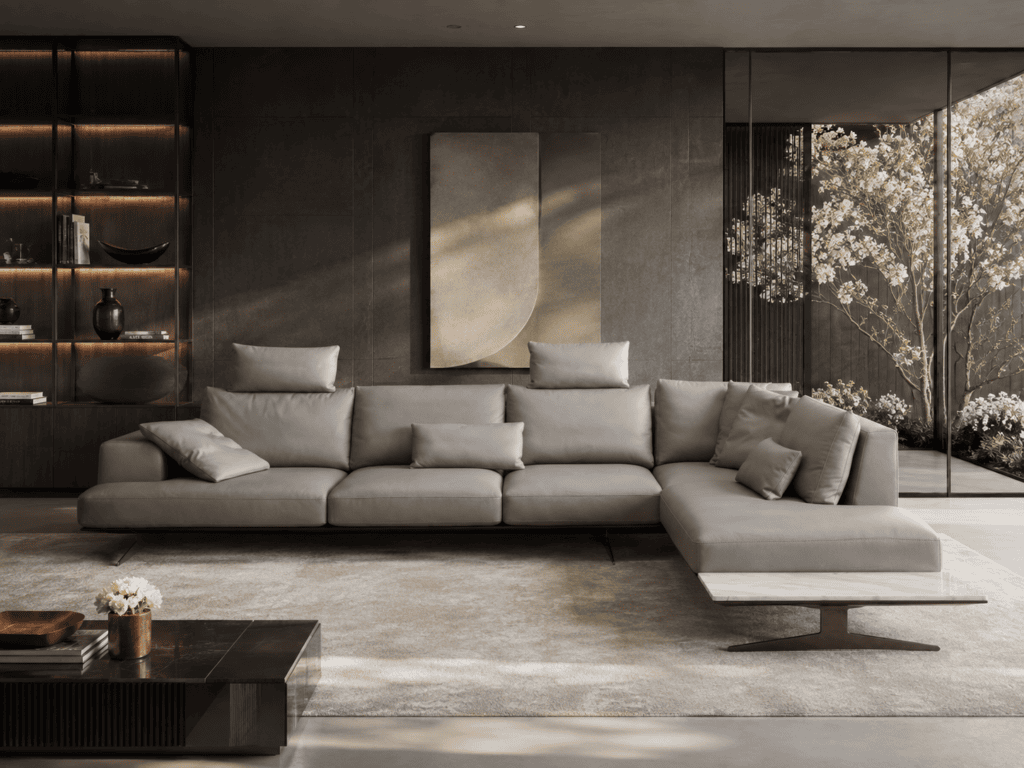 Modern living room with grey sectional sofa and large window with view of trees.