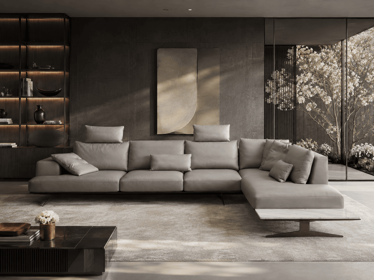 Modern living room with grey sectional sofa and large window with view of trees.