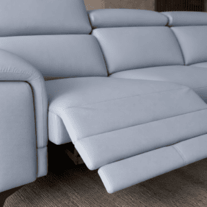 Modern light grey sectional sofa with adjustable footrest in living room.