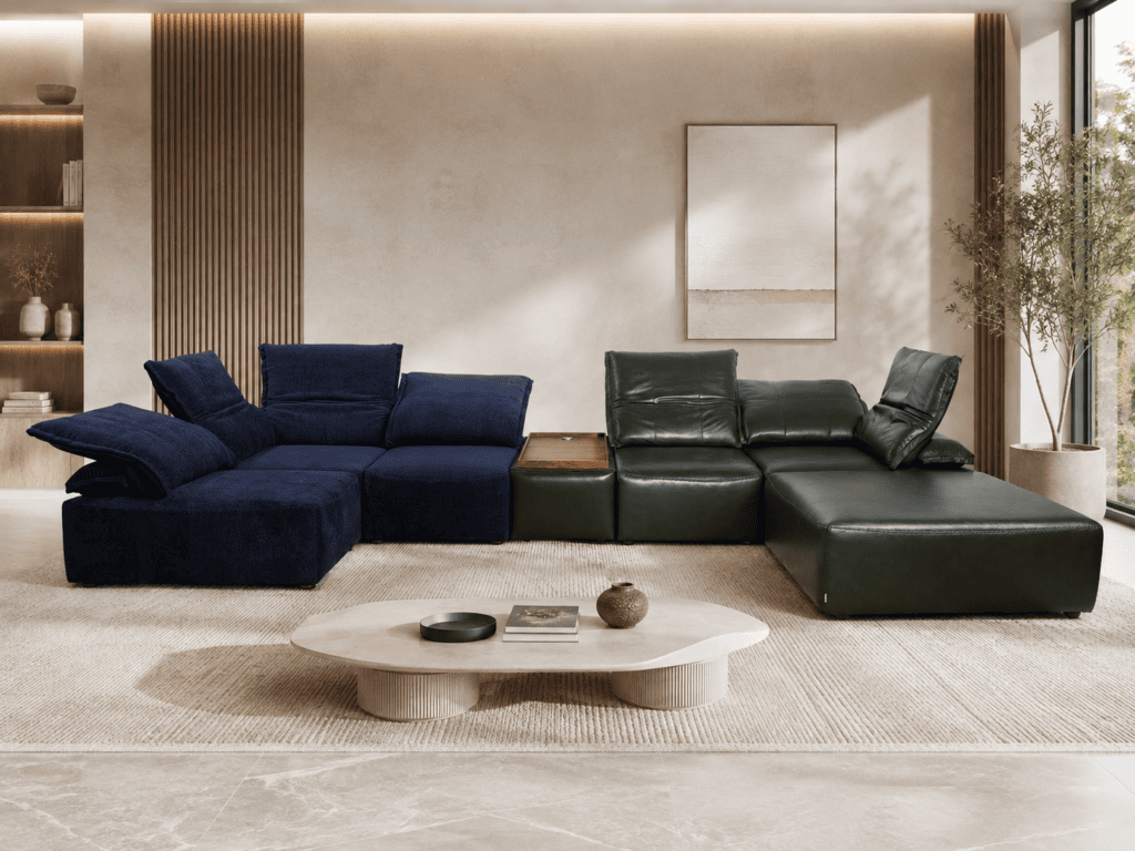 Modern living room with navy and green sectional sofas, coffee table, and natural light.