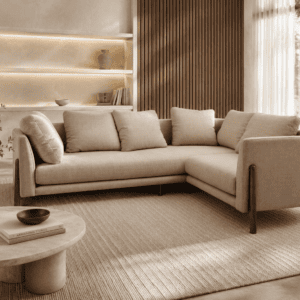 Modern beige L-shaped sofa in a stylish living room with natural light.