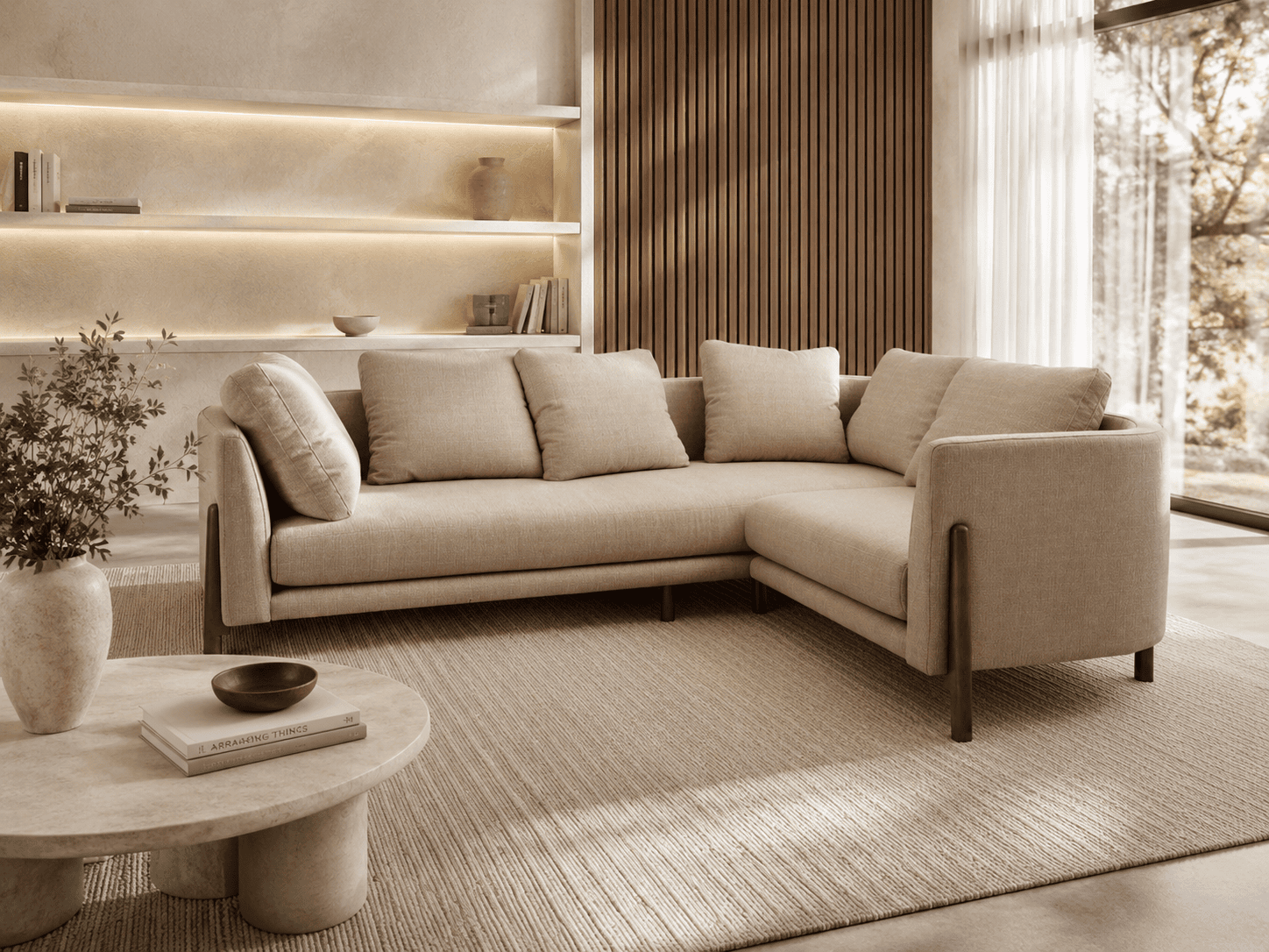 Modern beige L-shaped sofa in a stylish living room with natural light.