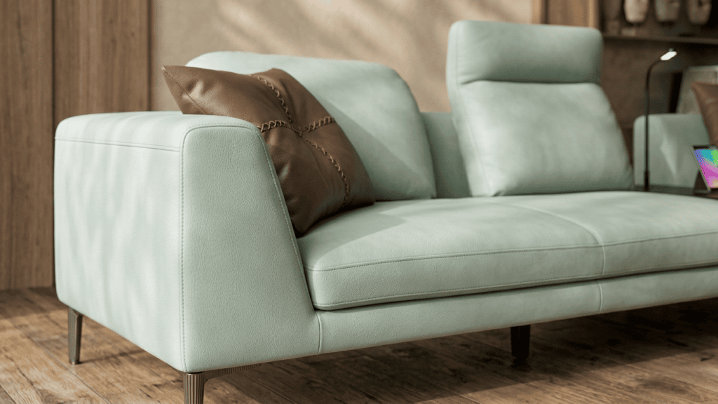 Modern mint green sofa with brown cushion in stylish living room setting.