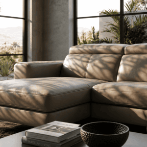 Modern beige leather sofa in a bright, stylish living room with large windows.
