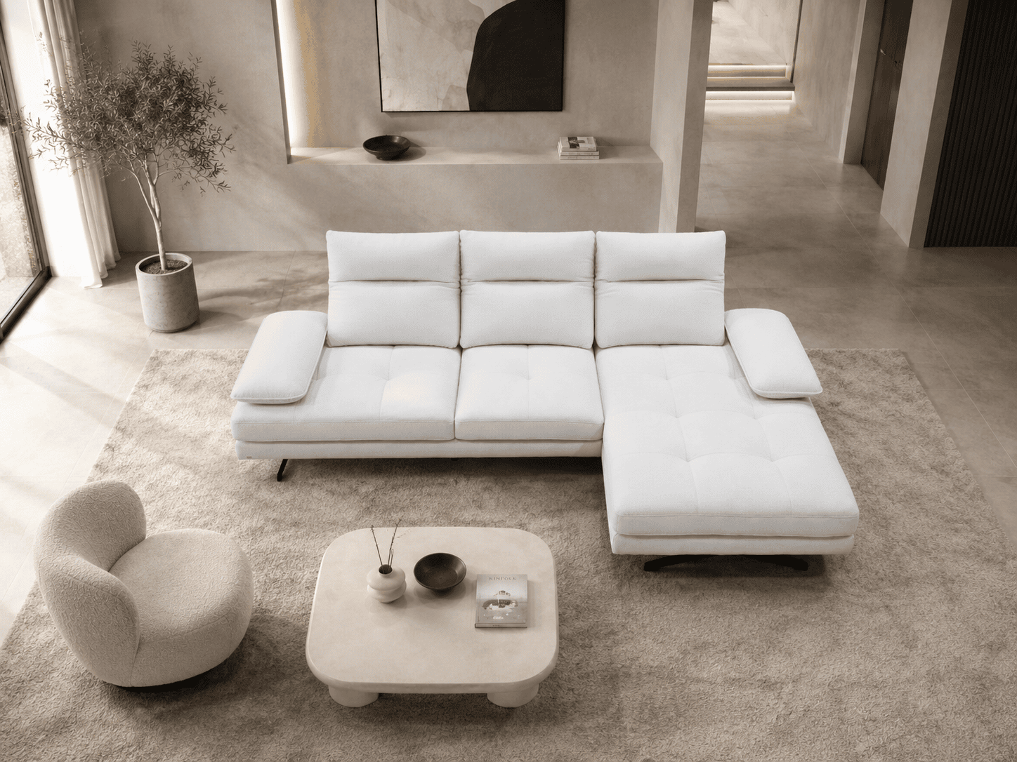 Modern white sectional sofa with chaise lounge in stylish living room.