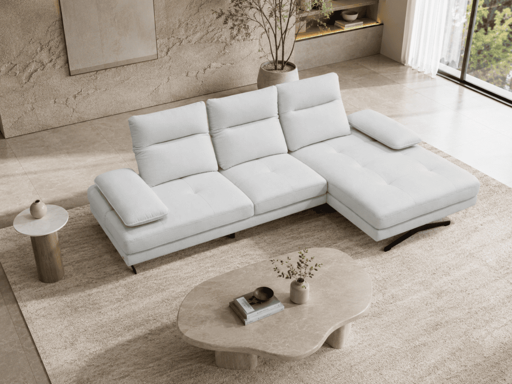 Modern white sectional sofa in a stylish living room with large window and decor.