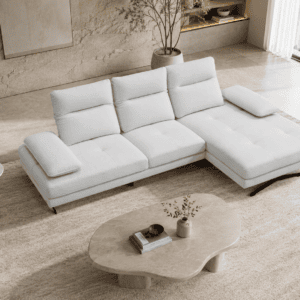 Modern white sectional sofa in a stylish living room with large window and decor.