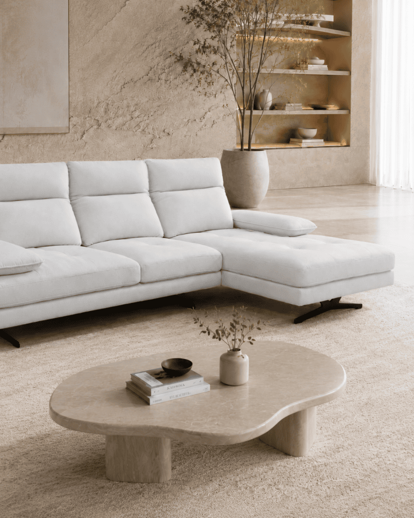 Modern living room with white sofa, beige rug, and minimalist decor.