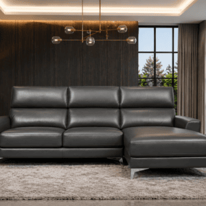 Modern black leather sofa in stylish living room with large windows and city view.