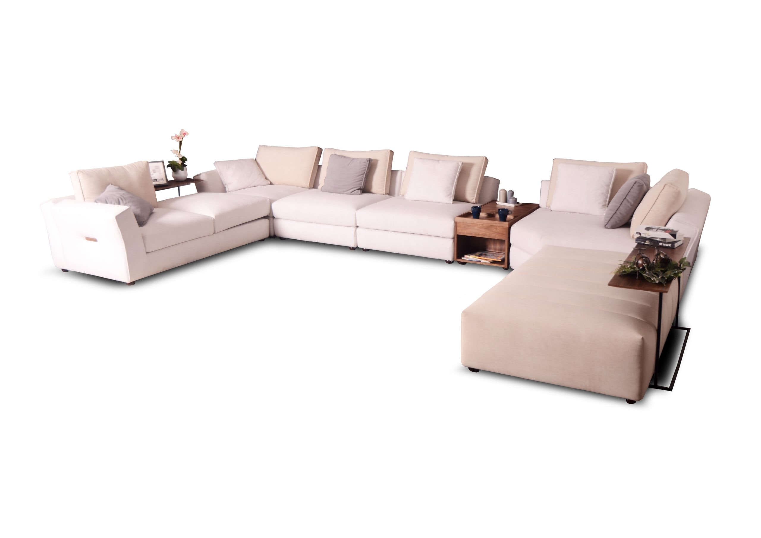 A comfortable L-shaped beige sofa with cushions and side tables, modern living room furniture.