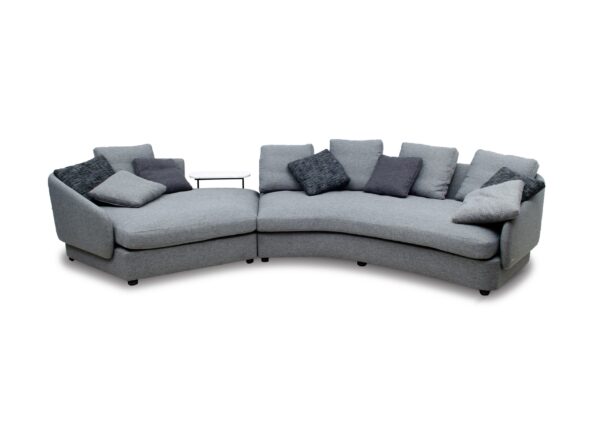 Modern grey sectional sofa with cushions, ideal for contemporary living rooms.