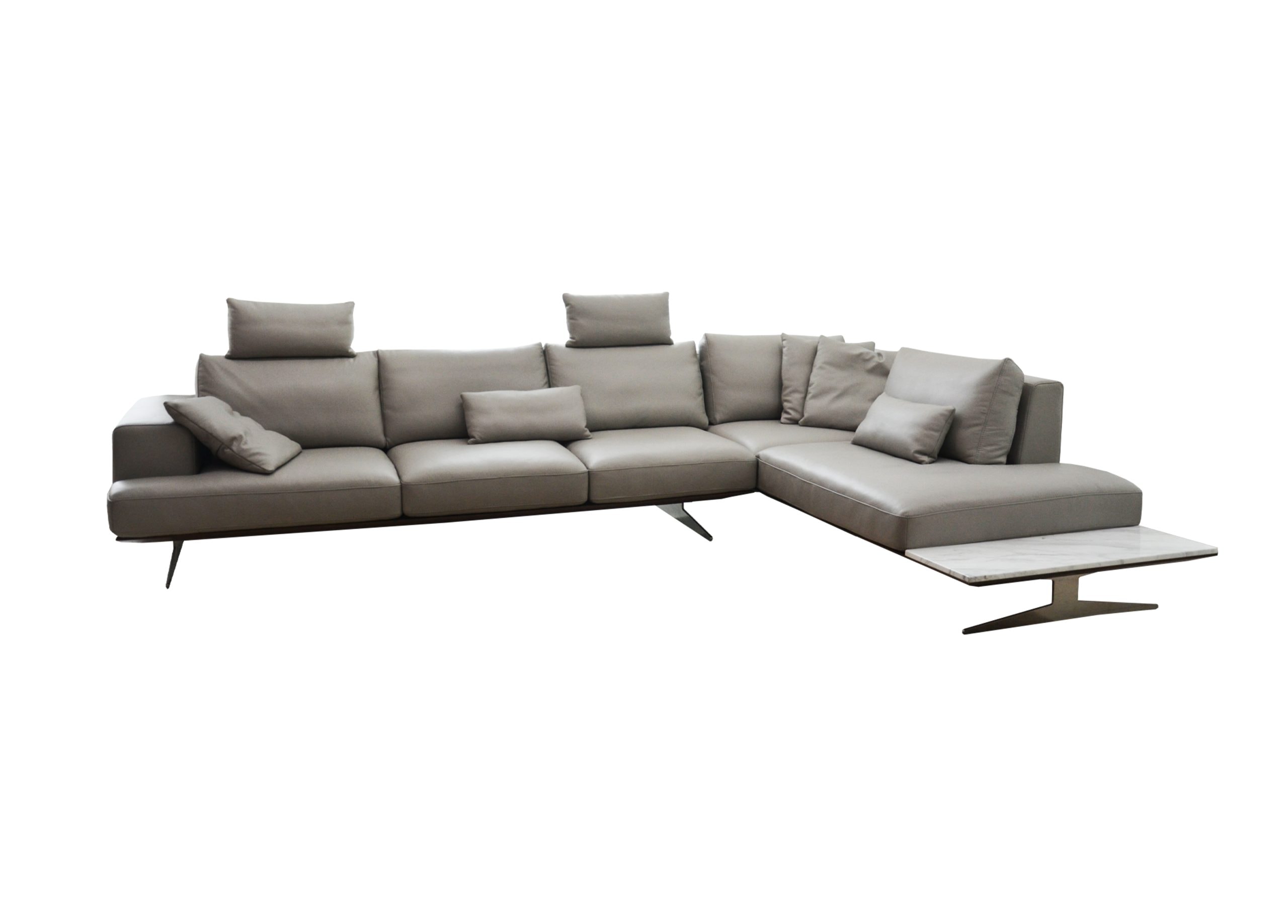 A comfortable grey sectional sofa with cushions and a modern wooden coffee table.