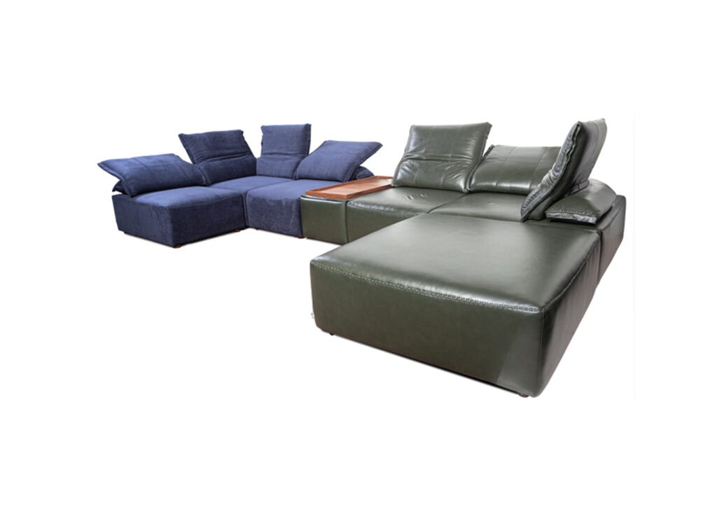 Modern sectional sofa with blue and green leather upholstery and cushions.