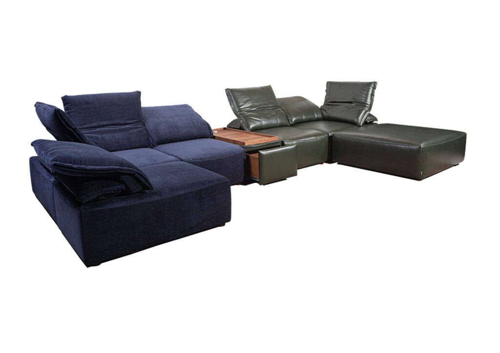 Modern sectional sofa with navy and green upholstery and wooden side table.