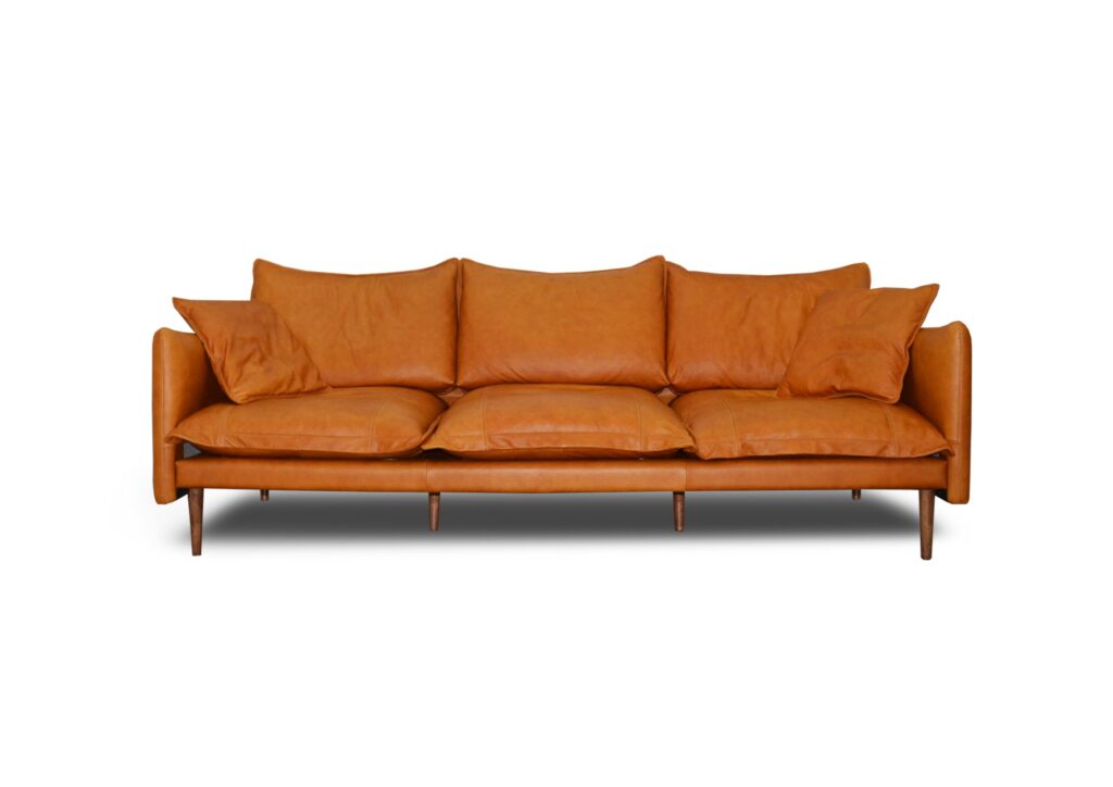 A sofa with orange upholstery and multiple cushions, modern living room furniture.